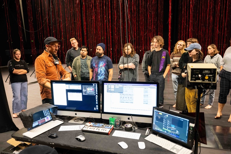 Artist Andrew Schneider talks to UI Theatre Arts students about his piece, N O W I S W H E N W E A R E (the stars)